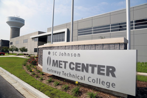 Exterior of SC Johnson iMET Center with sign in front and watertower to the back