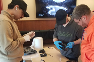 Gateway students repairing electronics