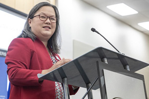 Dr. Tran addresses an audience from a podium