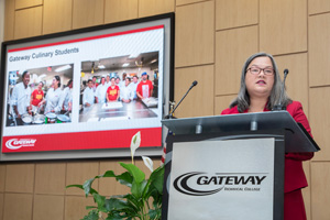 Dr. Veronique Tran speaks at a podium at the Inauguration Event