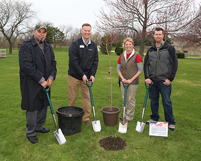 Gateway student-veteran Erik Kent, Gateway President and CEO Bryan Albrecht, Gateway Horticulture instructor Courtney Greve and Kevin Nolan plant Survivor Tree during ceremony.