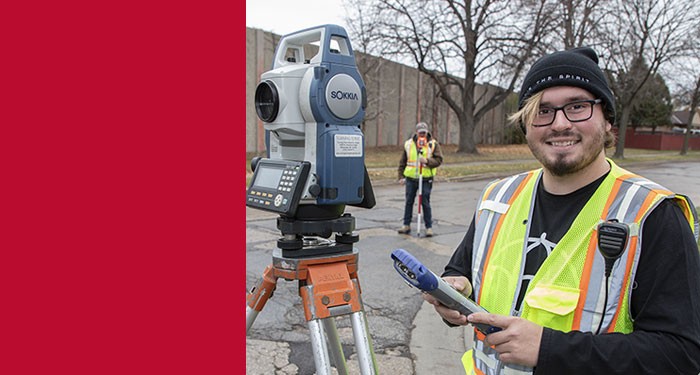 Logan learning to use surveying equipment