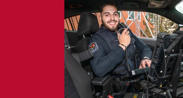 Criminal Justice student in a training police car