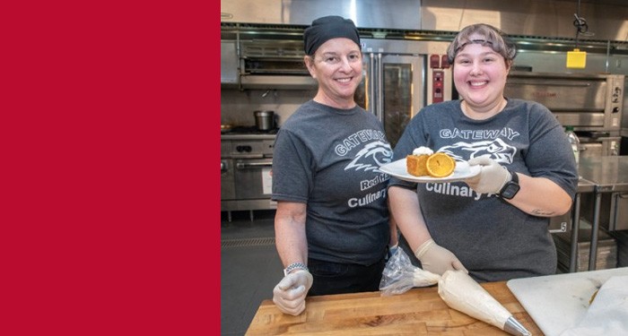 Culinary Assistant students in the kitchen holding a prepared desert