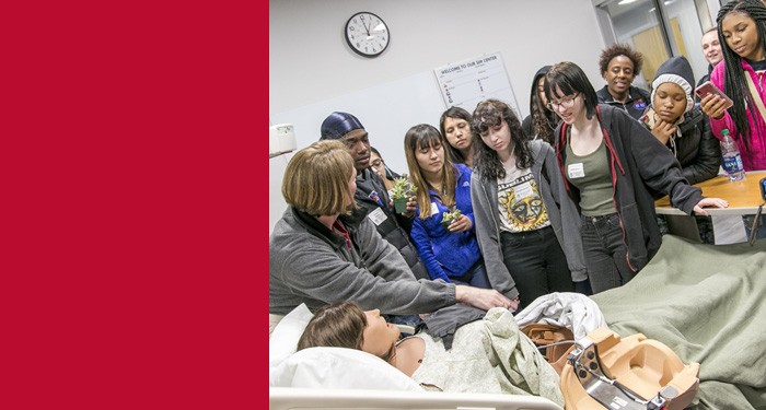 High School students touring a nursing lab on campus