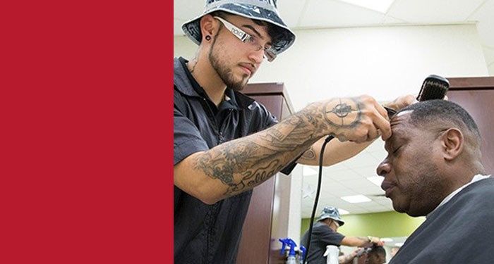 Gateway barber student giving a haircut at the Veterans Cut-a-thon event