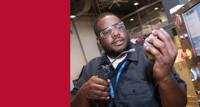 Apprenticeship student working with a CNC machine