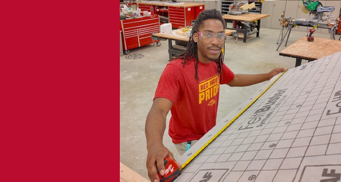 Gateway student, Roy Hamilton, measuring at a table.