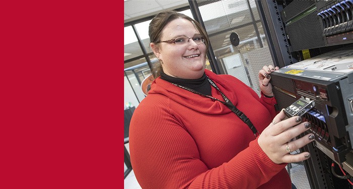 Marina Schwenk standing beside a server 