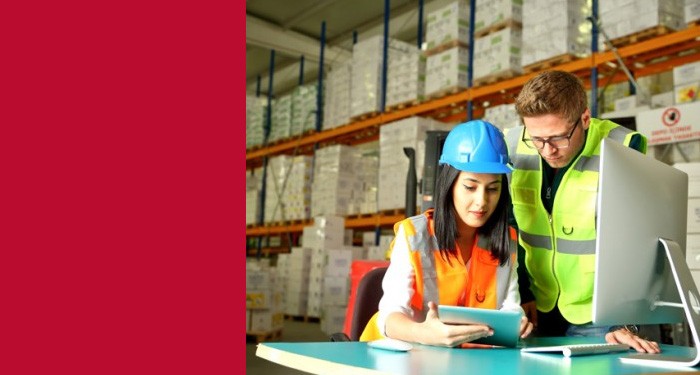 Gateway Supply Chain students at a computer terminal in a warehouse