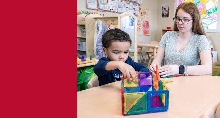 Gateway Early Childhood Education student builds a colorful geometric structure with magnetic tiles at a classroom table with a young student.