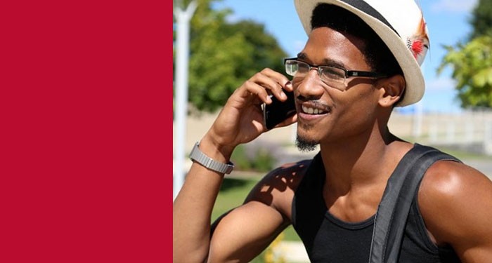 Gateway student outside in the fall on his smartphone