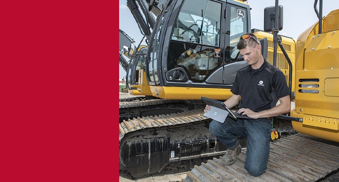 Sam Pittsenbargerby a diesel vehicle running diagnostics on a tablet