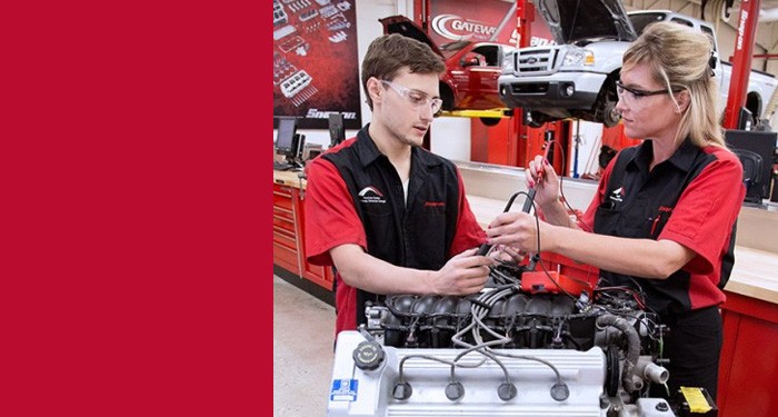 Two Gateway Automotive Maintenance Technician students work together using a multimeter to diagnose a problem.