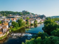 Aerial view of Marburg, Germany with stunning architecture, surrounded by lush greenery and a river valley.