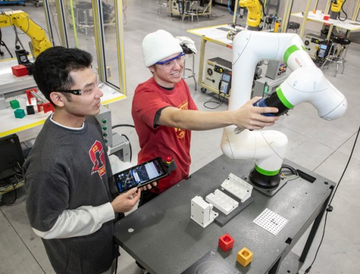 Advanced Manufacturing Technology students learning robotics in a lab