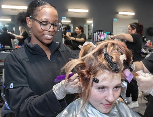 Cosmetology student with client in salon