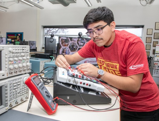 Electrical Engineering student in Gateway lab with equipment