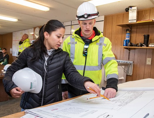 Construction students looking at blueprints