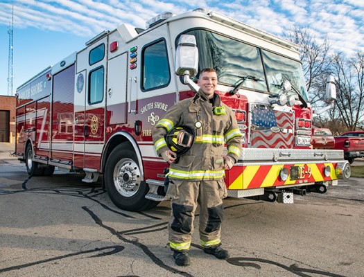 Firefighter technician student by firetruck