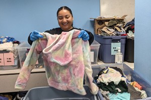 Volunteer sorting donated clothing