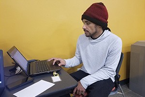 Student repairing laptop at the PC Clinic