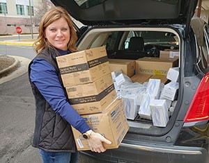 Vicki Hulback loading medical suppies to donate