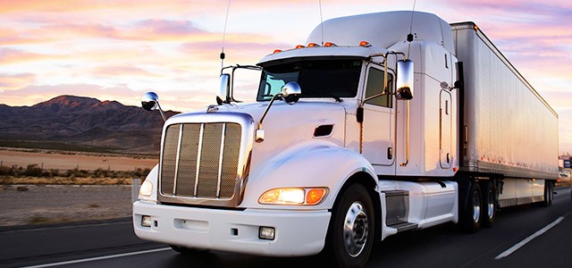 Large white freight truck at sunset
