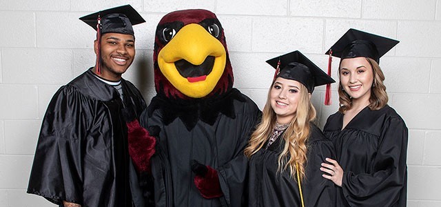 Rudy the Red Hawk with graduates