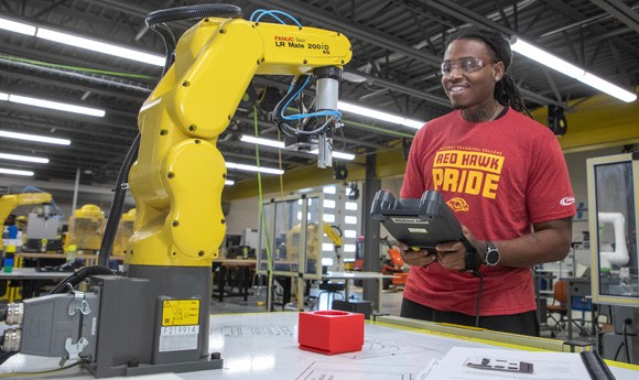 Advance Manufacturing student controls a robotic arm