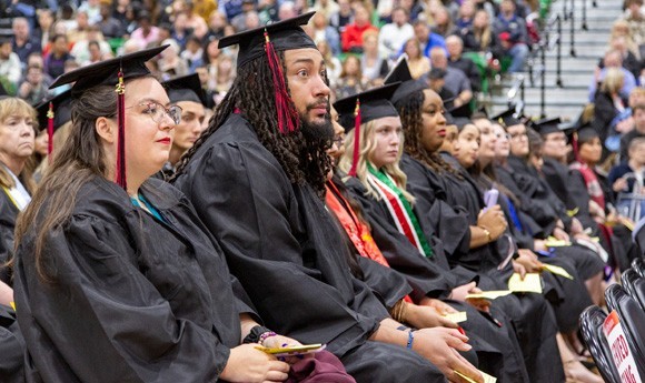 Students at their commencement ceremony in caps and gowns