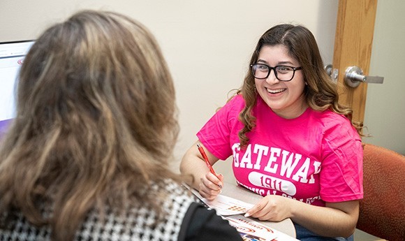 Student talking with a Gateway student services staff member in their office