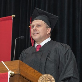 Jeremy Butler, student responder, speaks at podium at Gateway's 2026 Commencement Ceremony