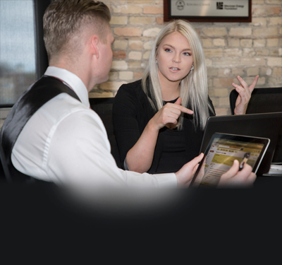 Two Gateway business students talking with each other.