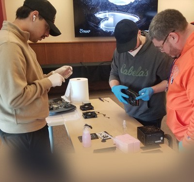 Gateway students repairing electronics
